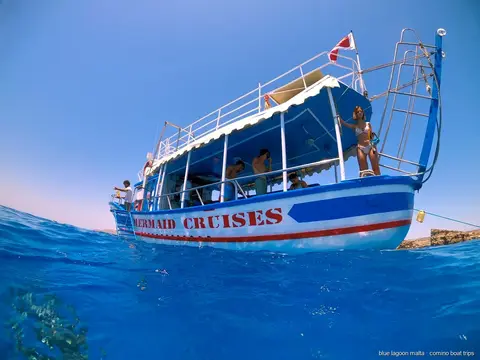 Passengers jumping from the boat into the Blue Lagoon