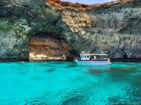 Small group boat near the sea caves off Comino