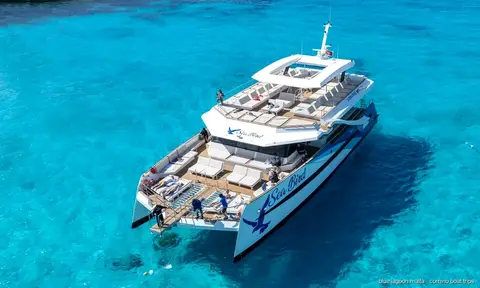 White catamaran anchored over the turquoise water of the Blue Lagoon, Comino